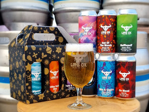 Christmas gift pack, cans and glass of beer