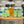 Load image into Gallery viewer, Cans of Little Ox Brewery Dog Days Are Over XPA with a pint full of beer on a background of kegs.

