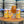 Load image into Gallery viewer, Three cans of Little Ox Brewery 'Tropic Like It's Hop' beer, including two labeled cans and a glass of beer, arranged on a  barrel with stacked kegs in the background.
